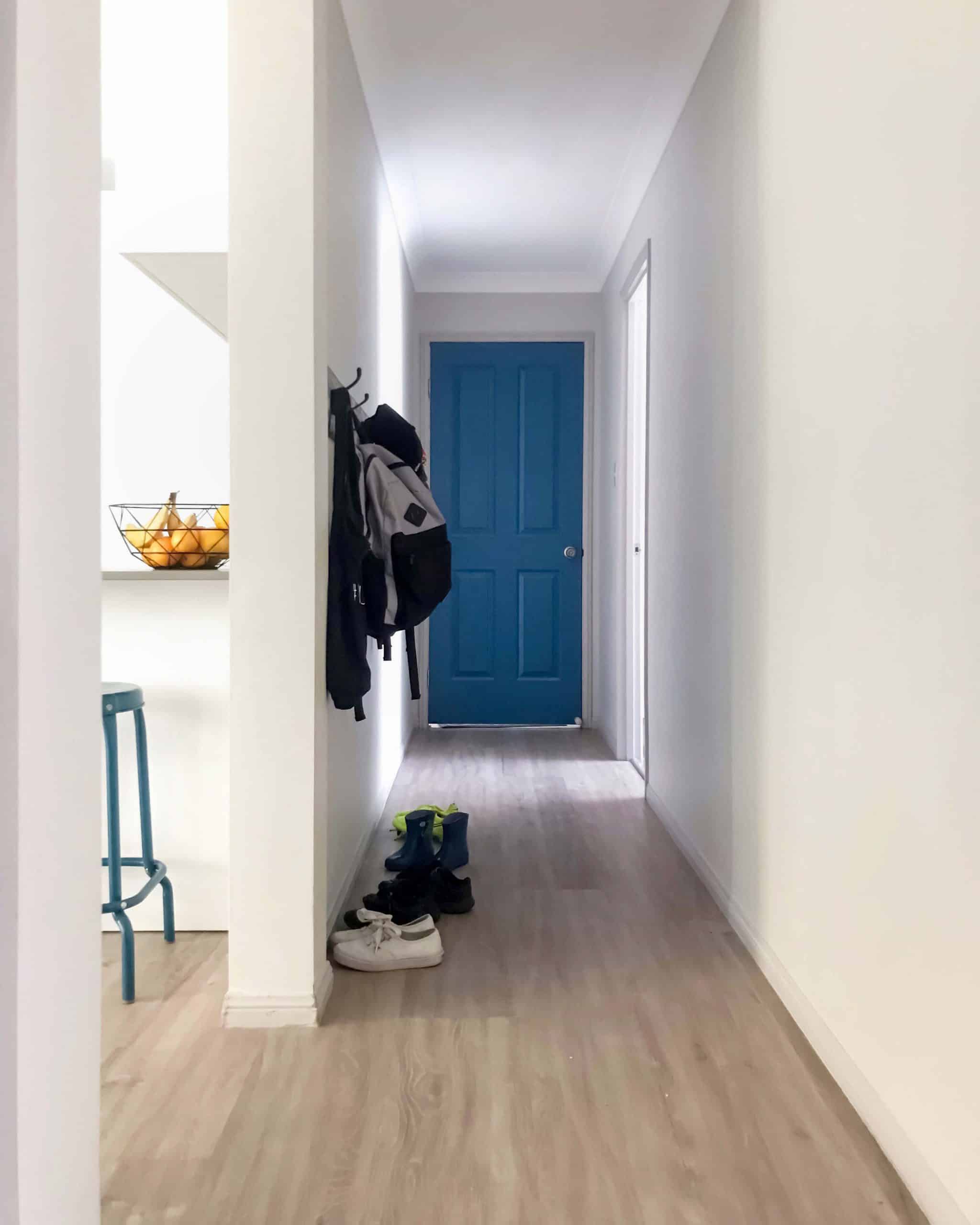 LooseLay in Pearl oak entry way hallway vinyl flooring blue front door